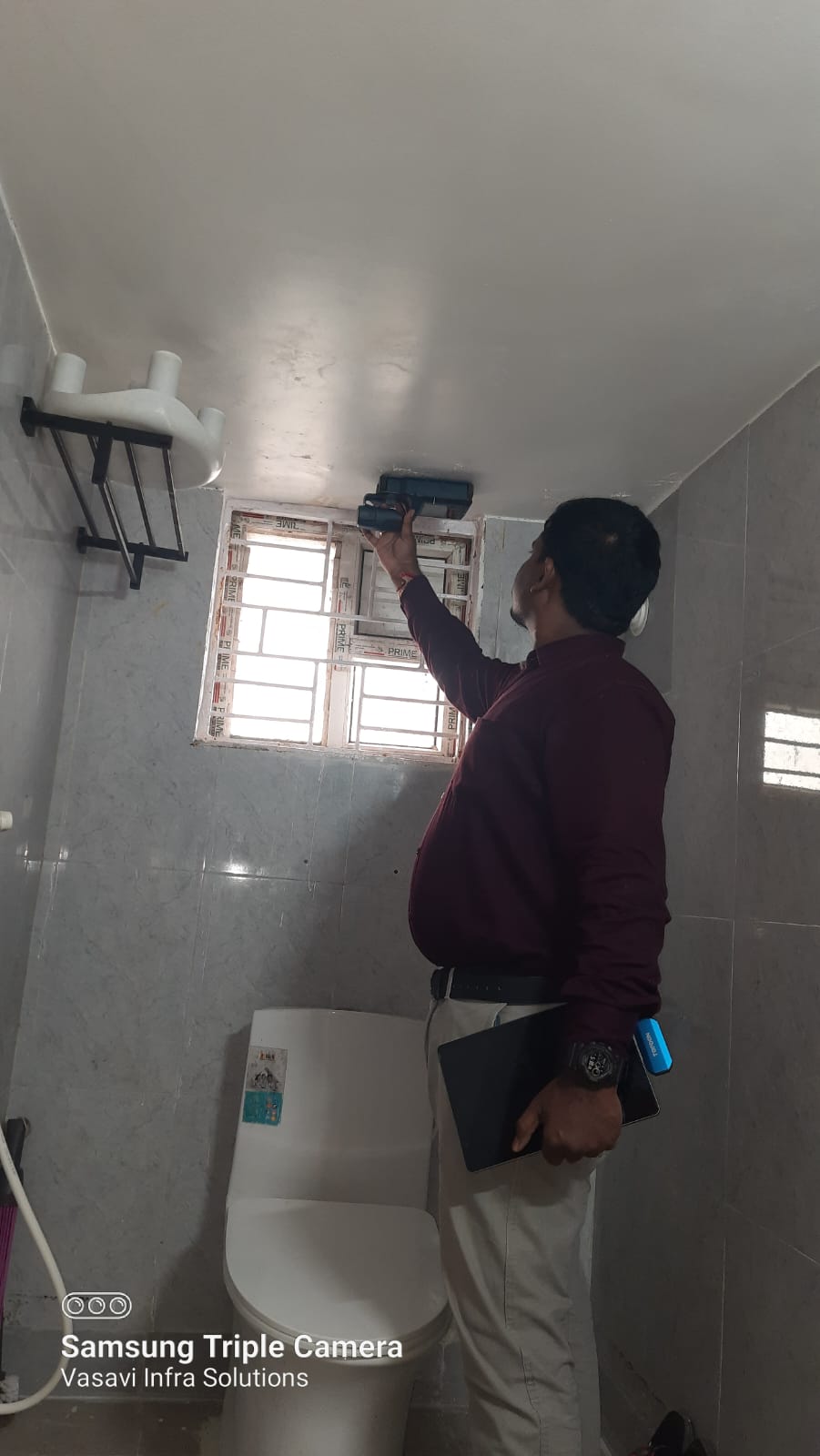 Inspector scanning wall area